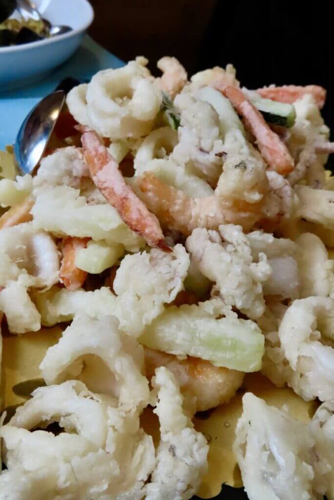 Fried seafood mix with calamari, shrimp, and vegetables.