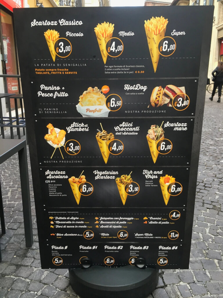 Italian street food menu: fried seafood, french fries, and hot dogs in Senigallia, Italy.